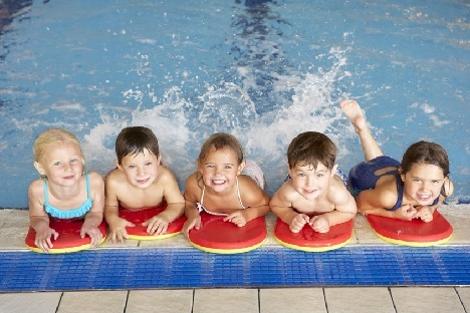 Fünf Kinder halten sich am Rande eines Schwimmbeckens fest. Quelle: © Monkey Business / Fotolia